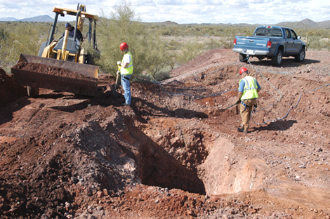 Backhoe and Hand Clearing of Waste Rock